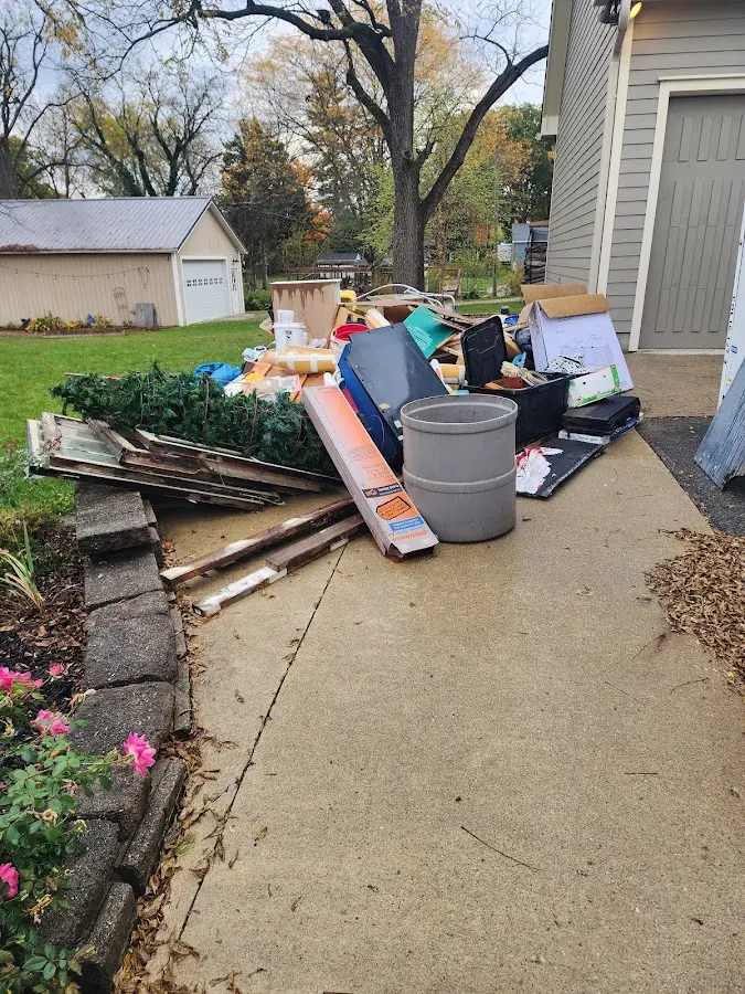 Dumpster being loaded with debris for Roofing Dumpster Rental in Edinboro